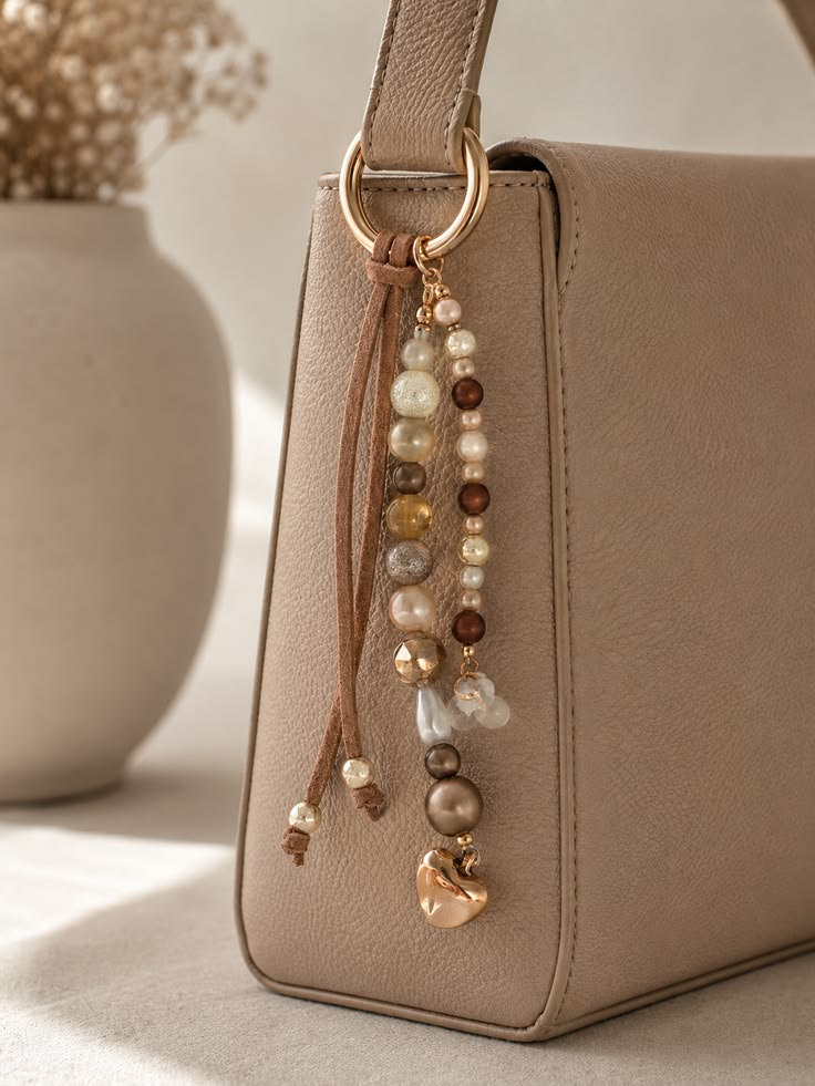 oréva beaded bag charm on a leather strap